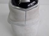 a silver container with a black lid sitting on a white surface