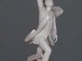 a statue of a man holding a sword on a table