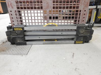 a picture of a large metal crate with a yellow sticker on it