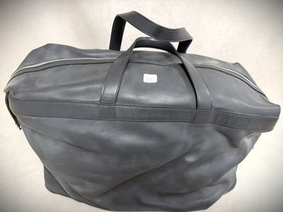 a grey bag with a black handle on a white background