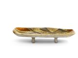 a small plate with a design on it on a stand