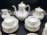 many pieces of china sitting on a black table