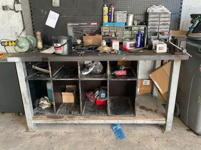 a workbench with many items on it in a garage