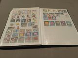 an open book with stamps on it sitting on a table
