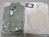 two pairs of shirts wrapped in plastic on a table