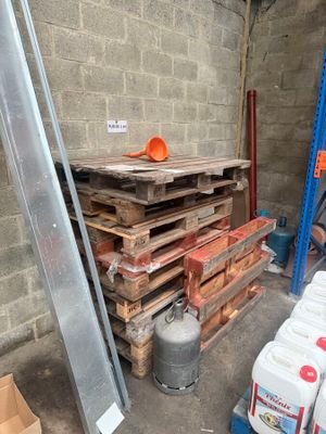 une pile de palettes et de conteneurs dans un entrepôt