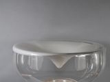 a glass bowl with a candle inside of it on a table