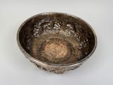 a silver bowl that is sitting on a table