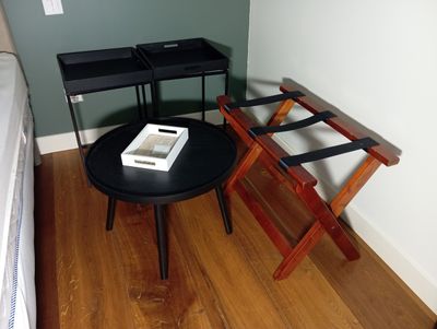 a small table with two trays on it in the corner of a room
