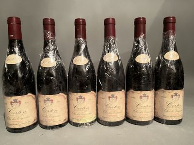 six bottles of wine are lined up in a row on a table