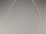 a gold plated necklace with the word love written on it