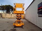 a picture of a yellow scissor in a parking lot