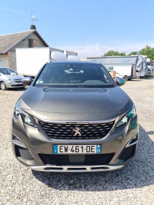 the front view of a grey car parked in a parking lot
