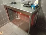 a metal table with a tray on top of it