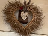 a heart shaped wreath with a deer ' s head on it