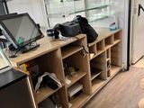 a small room with a desk, shelves, and a tv