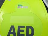 an aed sign on the back of a green chair