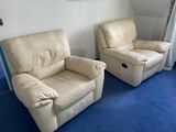 two recliners in a room with blue carpet