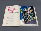 an open book with a picture of a plant in it