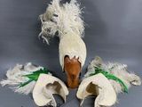 une paire de chapeaux blancs et verts ornés de plumes sur le dessus