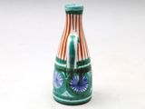 a small vase that has a blue flower on it