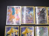 a lot of pokemon cards that are on the table