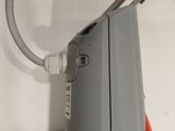 a gray and red computer mouse on a white surface