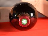 a bottle of wine sitting on a table next to a knife