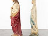 two statues of jesus and mary are standing in a row