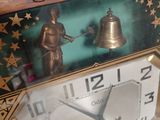 a clock that has a bell on top of it