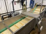 a conveyor belt in a factory with a lot of food on it