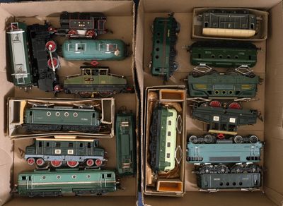 a lot of toy trains in a box on the floor