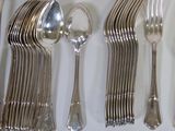 many spoons, forks, and spoons laid out on a table