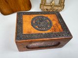 a small wooden box with a decorative design on it