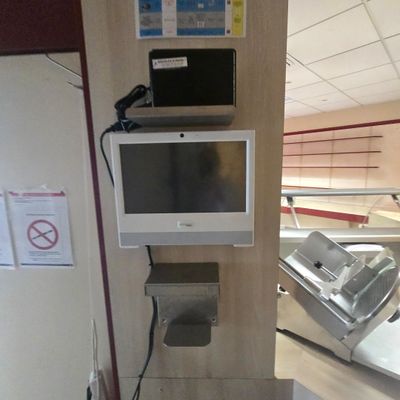 a television and a laptop on a shelf in a room