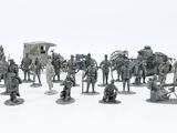 many figurines of different sizes and colors on a white surface