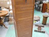 a wooden cabinet that is sitting in the middle of a room