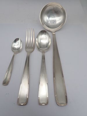 five silver spoons and two silver spoons on the table