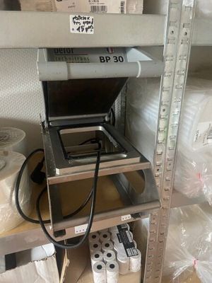 a metal shelf with a laptop on top of it
