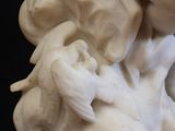a statue of a woman holding a bird on a table