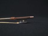 a close up of a bow on a black surface with a black background