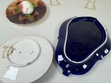 two plates and a bowl on the table next to each other