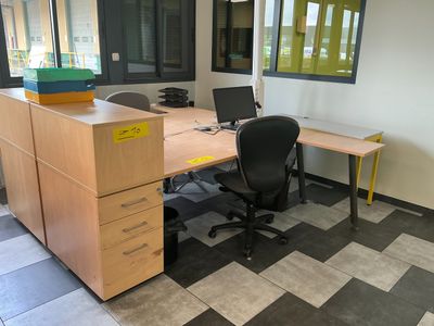 a desk with a chair and a computer on it