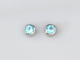une paire de boucles d'oreilles en topaze bleue sur fond blanc