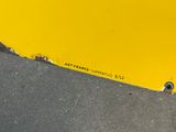 a yellow sign on the side of a yellow wall