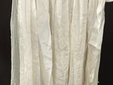 an image of a white skirt hanging on a hanger