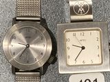 two watches sitting next to each other on a table