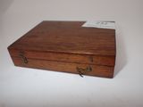 a small wooden box that has a tag on it