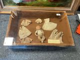a box with dolls in it sitting on the floor