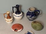 many different types of vases sitting on a table